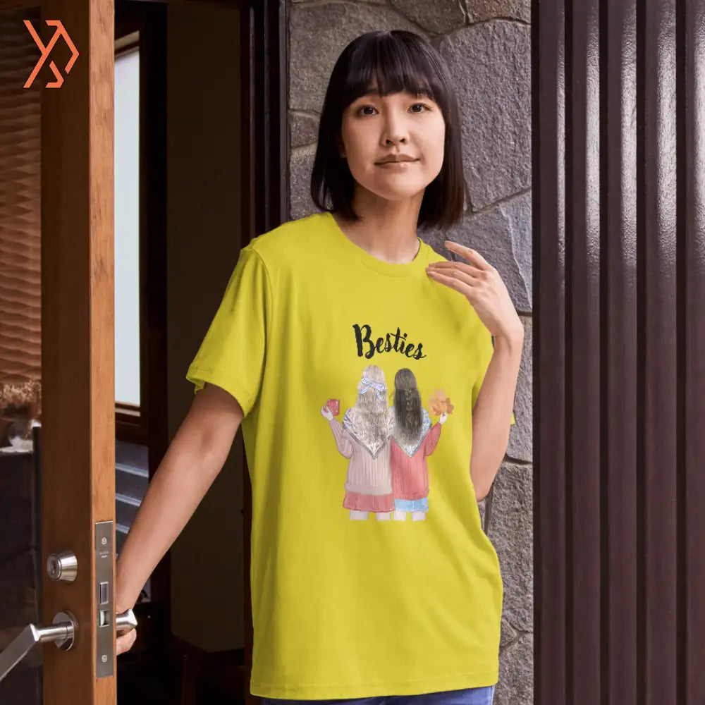 Person wearing a yellow t-shirt with a graphic design and text, standing indoors.