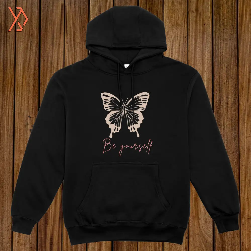 Black hoodie with butterfly design and 'Be yourself' text on a wooden background