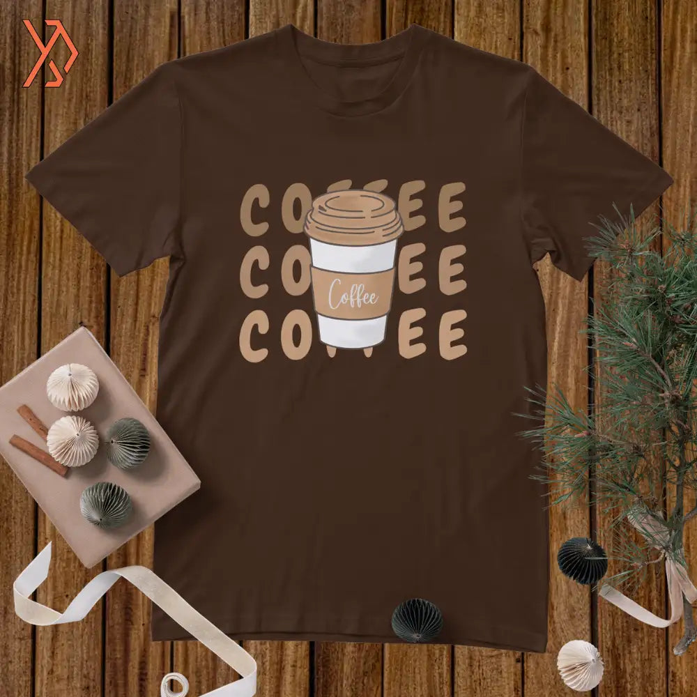Brown t-shirt with 'COFFEE COFFEE COFFEE' text and coffee cup graphic on a wooden surface.