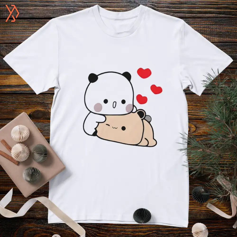 White t-shirt with a cute panda and bear design on a wooden surface. yourdora.pk