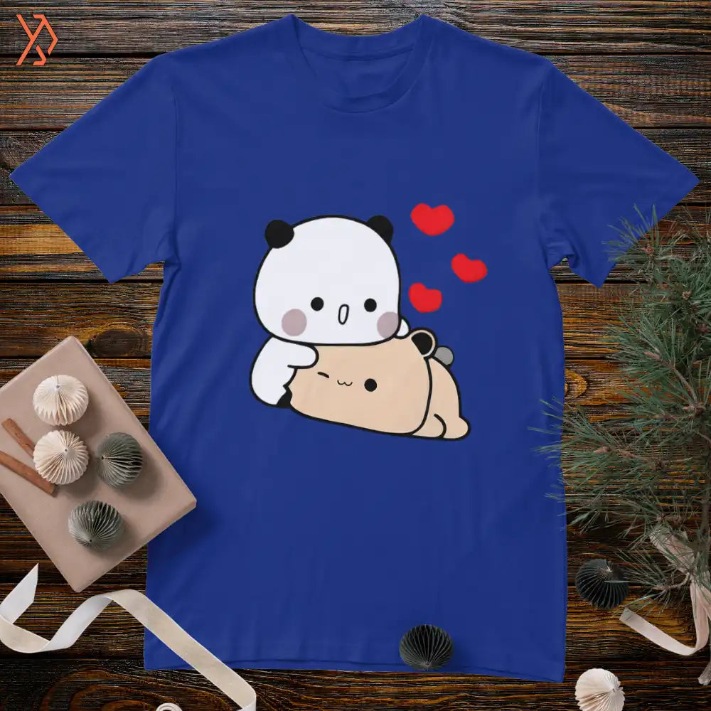 Blue t-shirt with a cartoon panda and bear design on a wooden surface. yourdora.pk