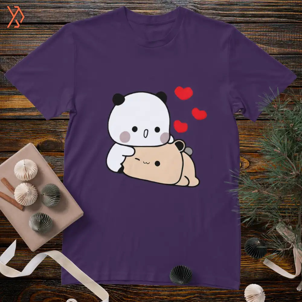 Purple t-shirt with a cartoon panda and bear design on a wooden surface. yourdora.pk